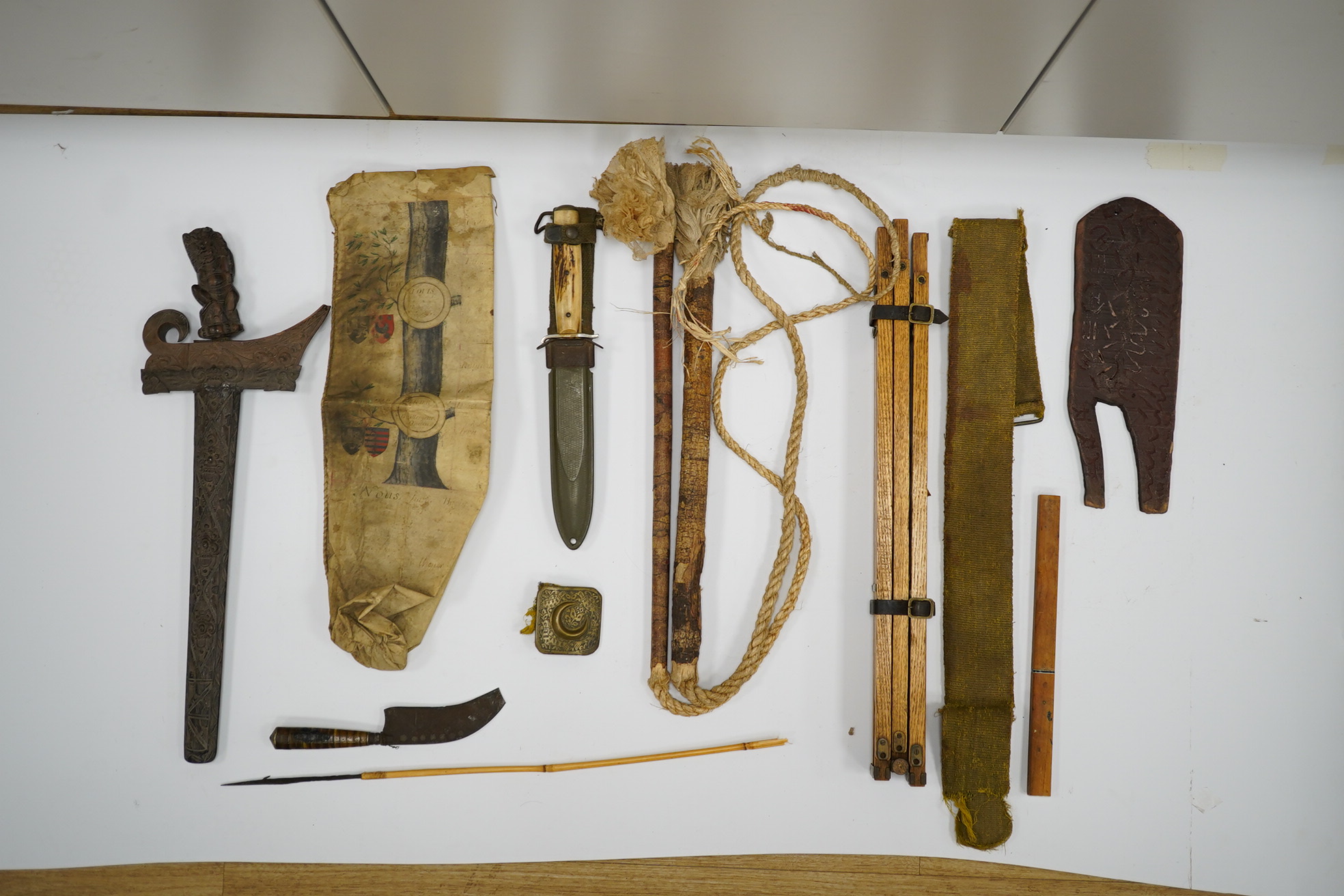 A section of a vellum family tree, converted into a bag, Together with an oak tripod, two whips, a Balanese Kris with lion man grip, a hunting dagger with horn grips, a small knife, etc. Condition - poor to fair